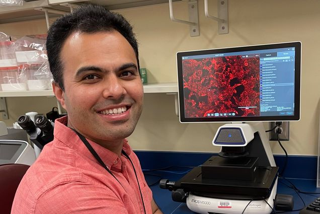 A photo of Mohsan Saeed working at a computer