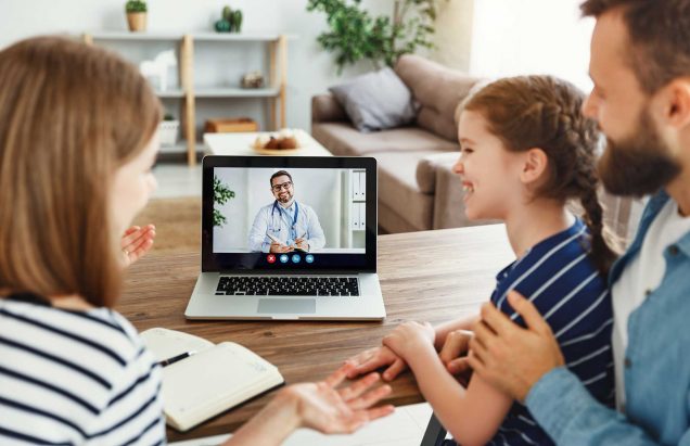 A young family conference with a doctor or therapist via a telehealth application on a laptop computer