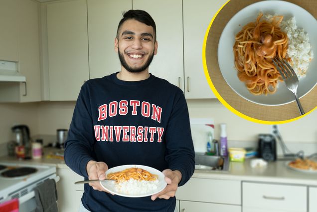 Photo of Riaz Butt-Garcia (CAS’22), wearing a blue BU sweatshirt with 'Boston University' written in red, holding a plate of Honduran spaghetti with white rice on the side. He stands in his kitchen, which is blurred, and a closeup photo of the spaghetti is overlaid in the top left with a yellow outline.