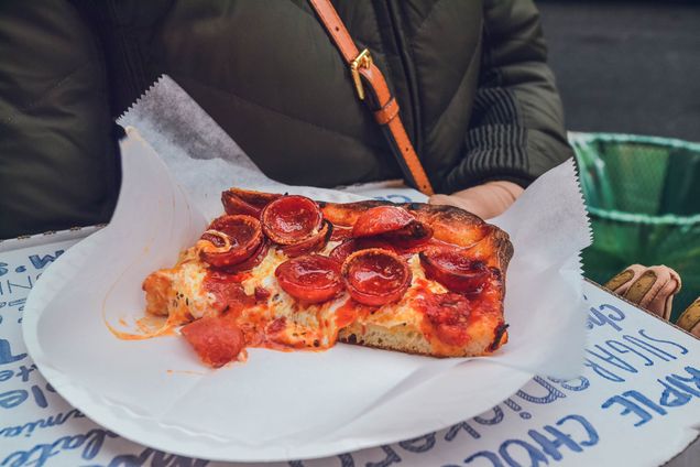 photo of a square slice of pepperoni pizza