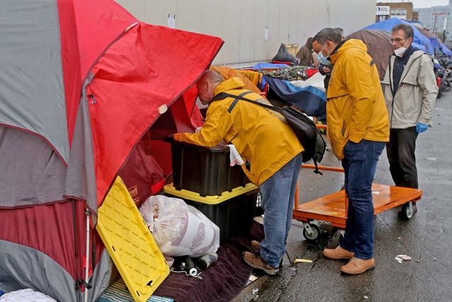 Boston public health officials encourage people to leave their tents in a homeless persons’ encampment near the intersection of Massachusetts Avenue and Melnea Cass Boulevard in Boston.