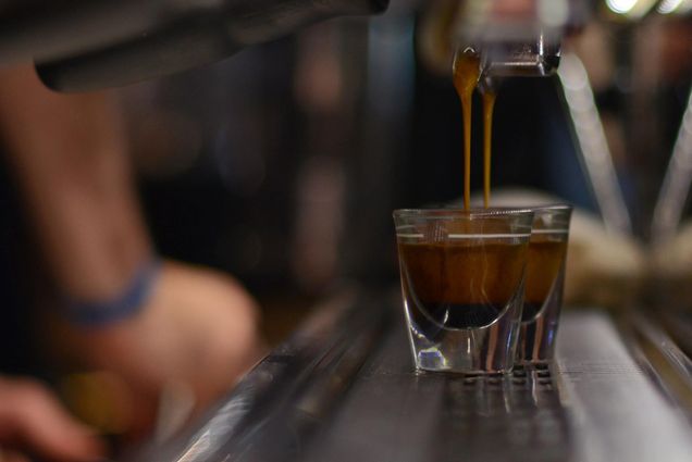 close-up photo of double espresso shots being poured from espresso machine in the Thinking Cup.