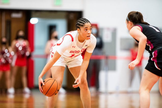 While primarily a scoring threat, Sydney Johnson (CAS’23) says her versatility can have an impact in multiple aspects of the game: “I try to do whatever the team needs to do that night.” Here Johnson stands dribbling a basketball on the court