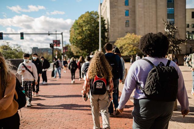 students walk in central campus at Boston University on a sunny day