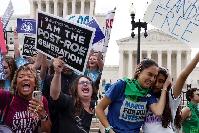 Composite image. At left, a diverse group of pro-life women celebrate in front of SCOTUS after Roe v. Wade was overturned. One woman holds a sign that says "I am the post Roe generation." At right, two young women with March for Our Lives t-shirts on embrace each other. The woman at left is weeping, the other holds her head in her arm.