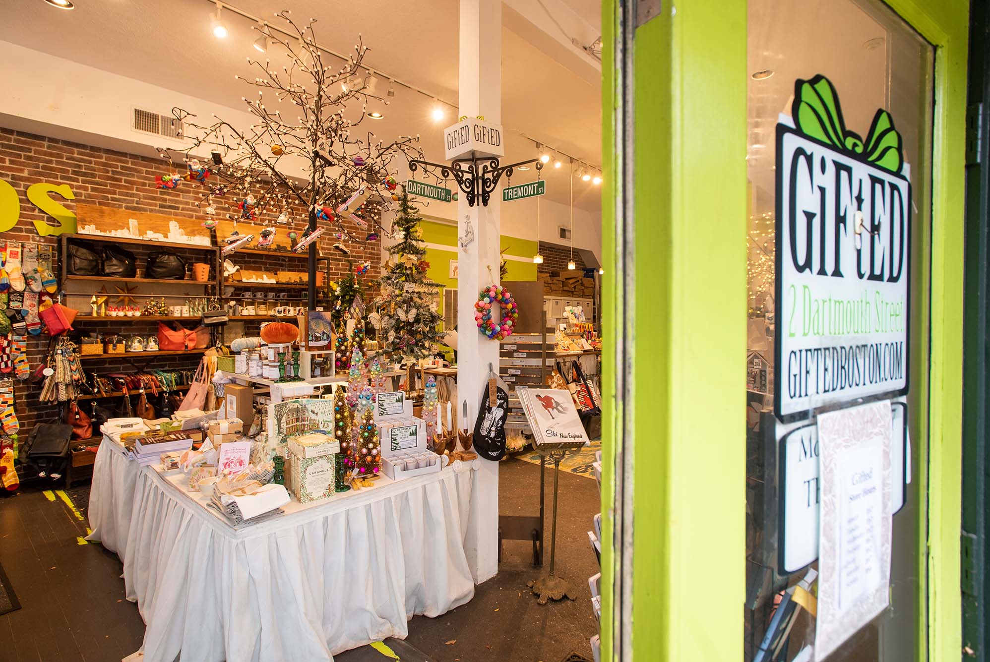 Photo: A peek into the Gifted Store in Boston. Front door sign reads "Gifted" and an interior filled with tables, fairy lights, and various boutique gifts are on display.