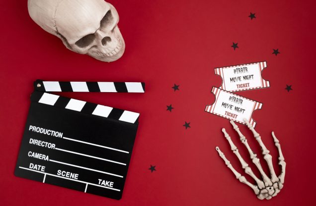 A movie clapperboard and halloween decoration. Horror movie night.