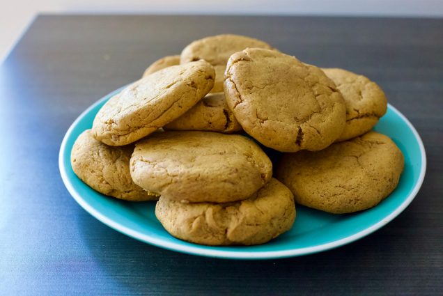 A plate of pumpkin spiced cookies on a brown table