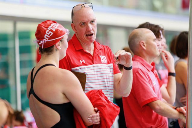 BU swimming and diving head coach Bill Smyth with Anastasia Belyakov (CAS’24) at a recent meet. On February 21, he announced plans to retire after 18 years helming the men’s and women’s swimming and diving programs. Photo by Kyle Prudhomme