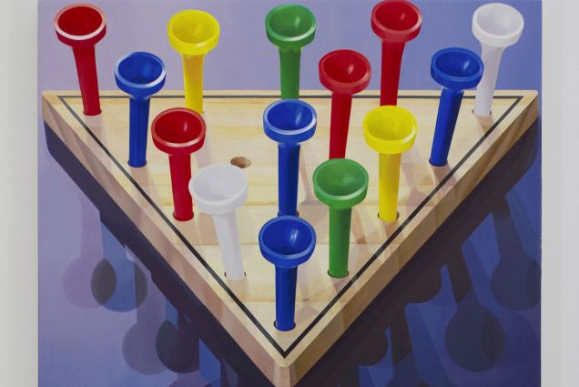 A triangular figure in wooden natural color with pegs like golf tees in various bright colors like red, blue and green. The background is blue with shadows of the golf tee figures.