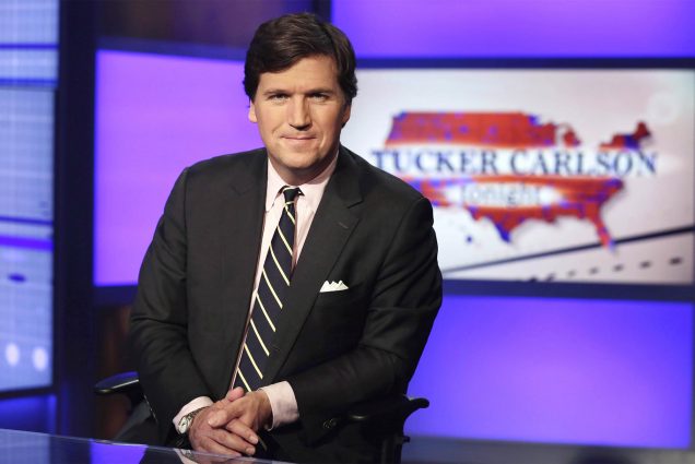Photo: Tucker Carlson, a white man in a suit, host of "Tucker Carlson Tonight," poses for photos in a Fox News Channel studio on March 2, 2017, in New York. (AP Photo/Richard Drew, File)