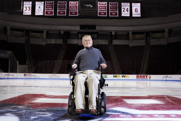 Photo: Travis Roy, a man in a wheelchair, poses for a photo in the center of a hockey rink on Monday, October 6, 2015 at Agganis Arena Photo By Jackie Ricciardi for Boston University Photography
