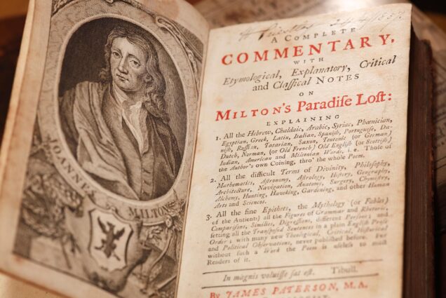 Photo: Milton's Paradise Lost, an old book with old english type laying on a table. There is an illustrated portrait of a man with long hair in old style clothes in the left cover of the book.