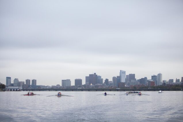 Photo: A collection of rowers in long boats are seen on the Charles River in Boston, MA on an overcast day