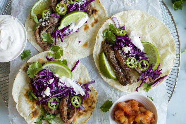 Photo: A platter of three steak and jalapeno tacos with limes on the side