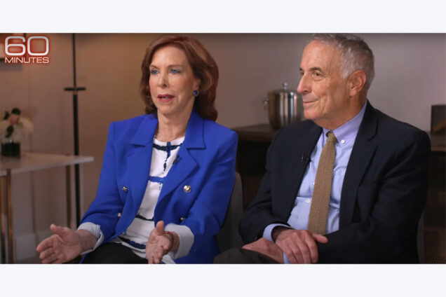 Screenshot: Coauthors Terry Savage (left) and Laurence Kotlikoff from Sunday’s 60 Minutes segment. Savage, a white woman with short brown hair and wearing a white and blue striped blouse and blue blazer sits next to Kotlikoff, a white man with grey hair wearing a light blue collared shirt, black blazer, and tan tie. The 60 Minutes logo is shown in the top lefthand corner.