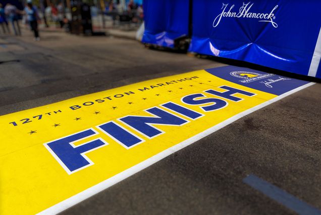 Photo: A wide shot of Boston Marathon's finish line--a yellow background with blue lettering that reads FINISH