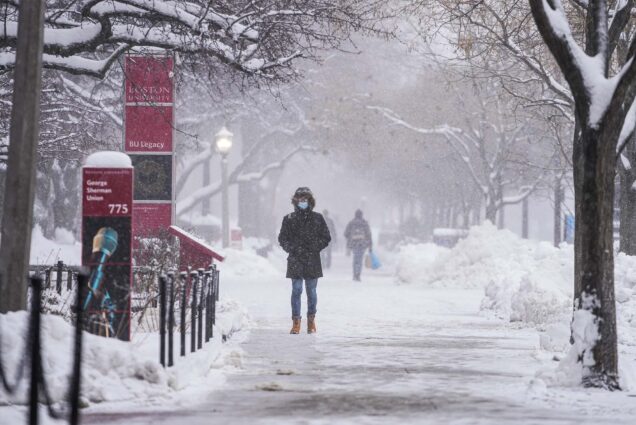 Photo: Students walk down a very snowy street in the middle of winter