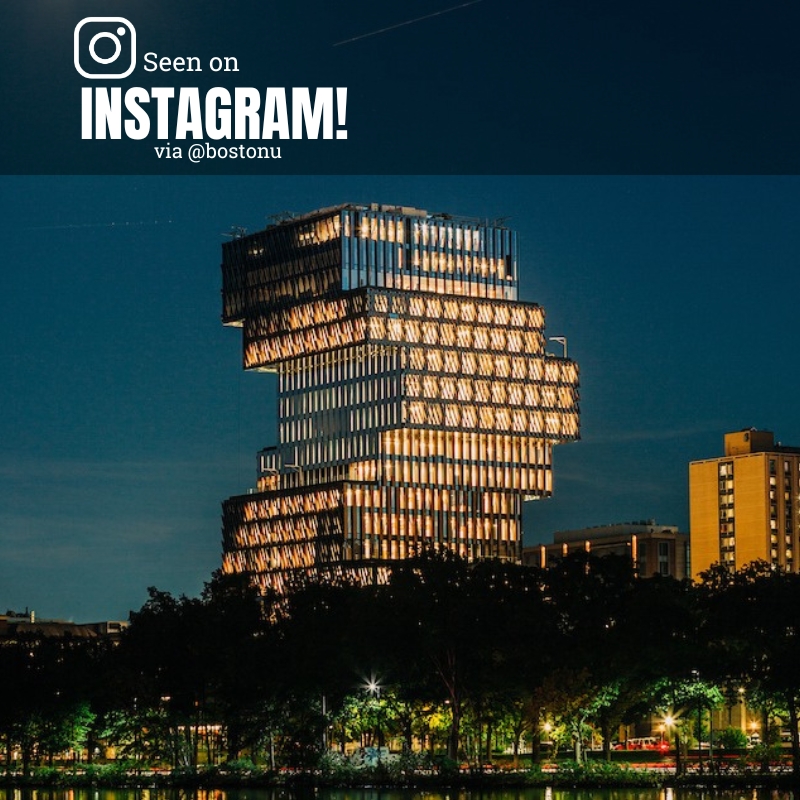 Photo: CDS building at night with the windows lit up in a dusk sky.