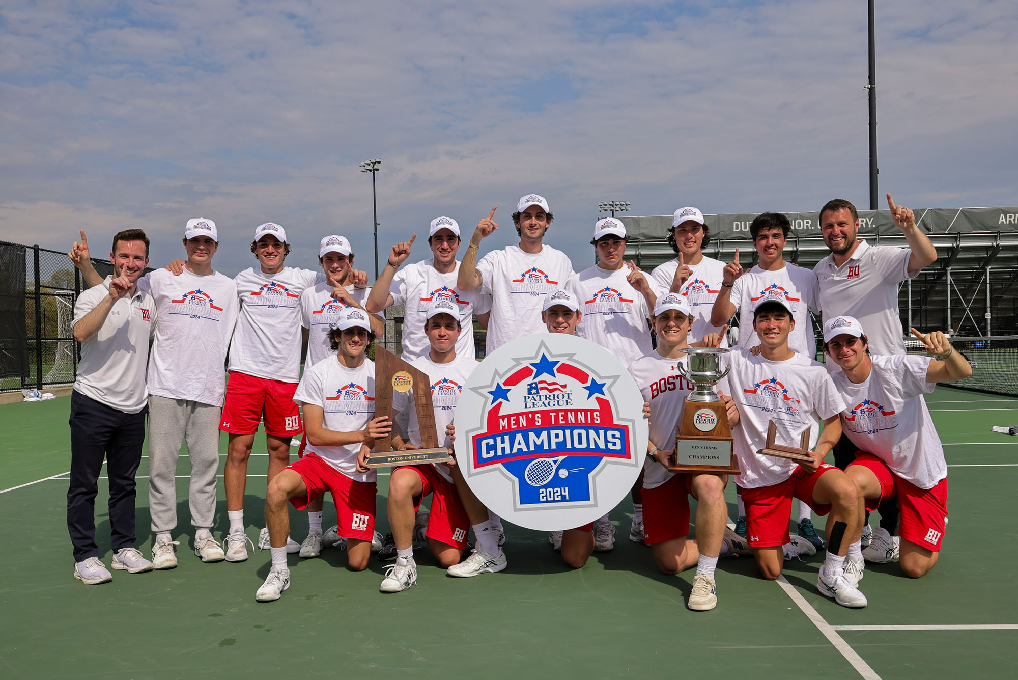 Photo: A picture of men posing with a sign that says "Patriot League Men's Tennis Champions 2024"