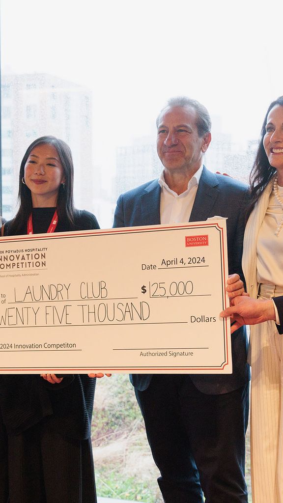 Photo: A picture of 6 people holding a large check for $25,000. They are dressed in formal attire