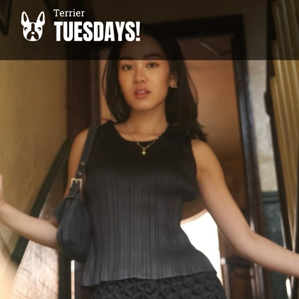 Photo: A picture of a girl with dark hair and a black top posing for the camera. Text overlay reads "Terrier Tuesdays!"