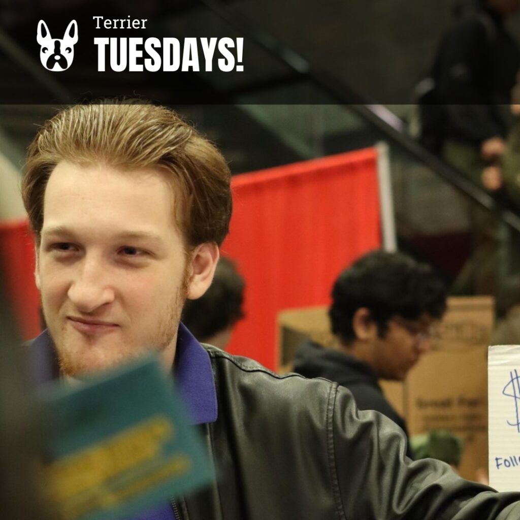 Photo: A picture of a man with light hair looking off to the side. Text overlay reads "Terrier Tuesdays!"