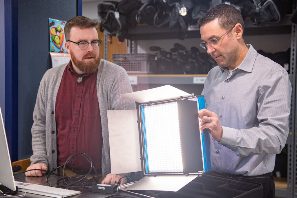 Photo: A picture of two men looking at professional lighting equipment