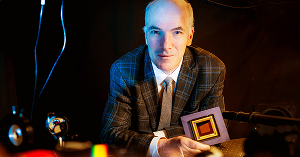 Photo: A picture of a man in a dark plaid suit looking at the camera