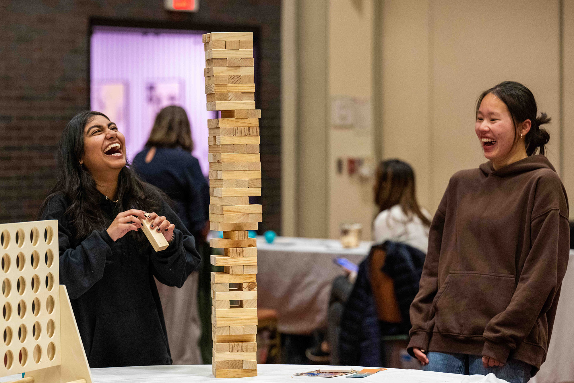 Photo: A picture of two girls laughing and playing Jenga