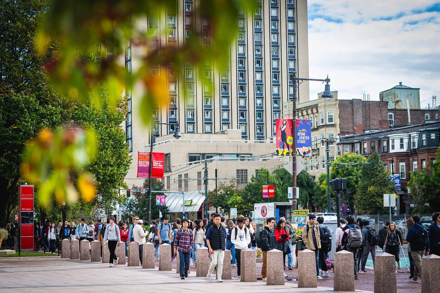 Photo: Commonwealth Avenue on BU's campus on a sunny day with many students walking