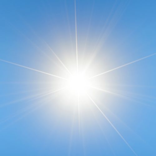 Strong sunlight glow against blue sky.