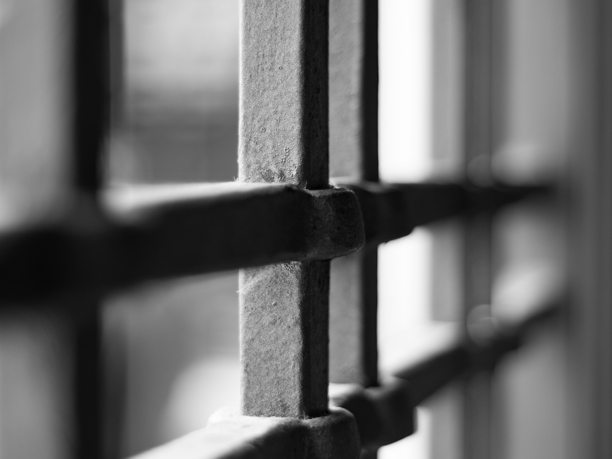 Black and white photo of prison bars