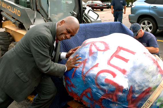 Dean of Students Kenn Elmore (top) during the BU Rock’s 2007 move. At its new home on the BU Beach, the rock is subject to color changes come snow or sun.