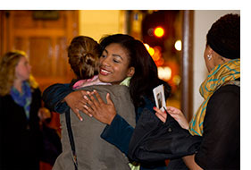 A quick embrace is exchanged before an Inner Strength Gospel Choir performance at Marsh Chapel. Photo by Vernon Doucette.