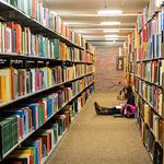 A student studying alone in Mugar Library.