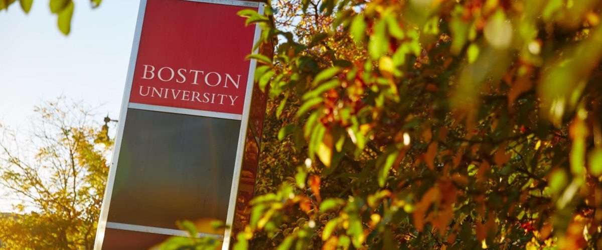 Red Boston University sign in leaves