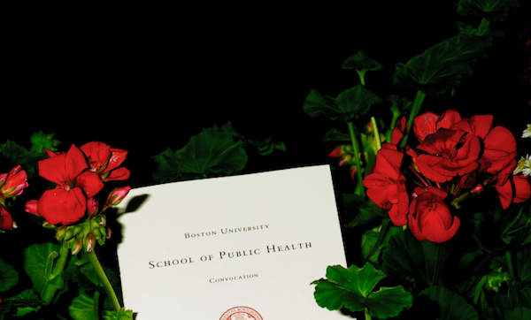 BUSPH Convocation pamphlet placed in red flowers