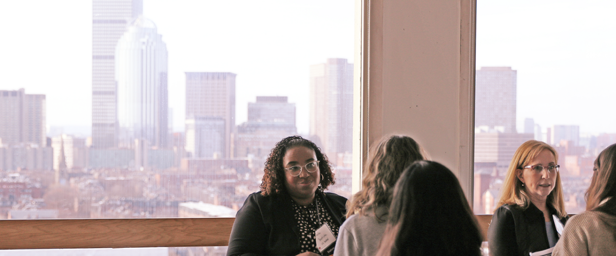 Employers and students at the 2023 Career Fair, with the Boston skyline in the background
