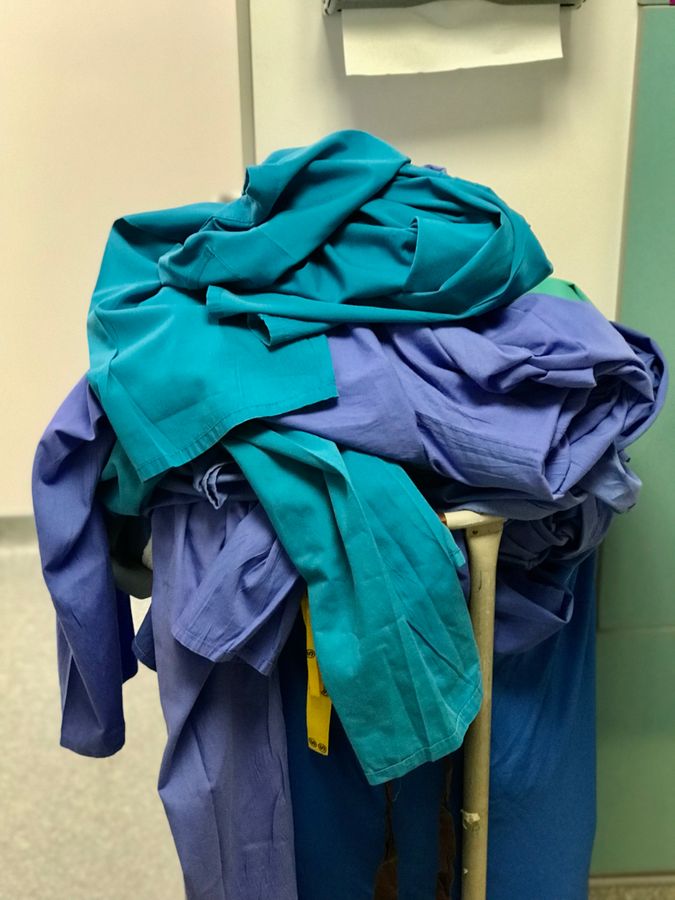 Medical scrubs piled high