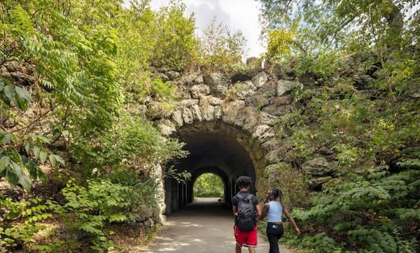 People walk into a tunnel at Franklin Park