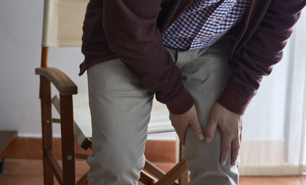 A middle-aged man has knee pain when he gets up from his seat. This man may have arthritis, rheumatism, osteoarthritis or osteoporosis.