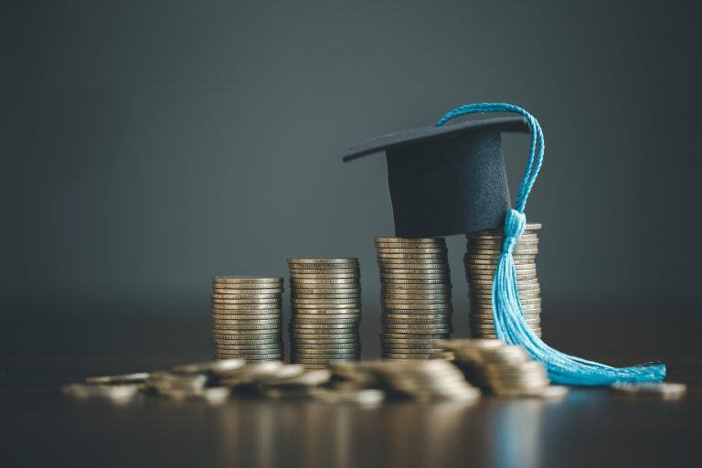 Saving money coins with education concept