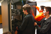 Boston University undergraduate students Michael Abed, Darko Stosic, Dusan Stosic, and Terry Black preparing for the SC11 Student Cluster Competition