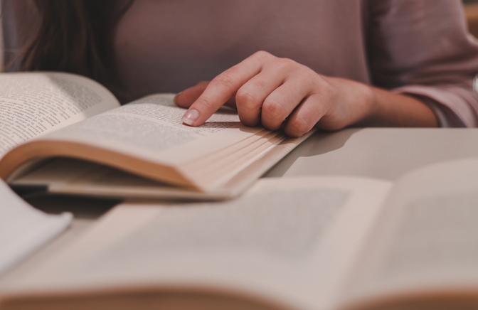 hand guides reader as she reads history book