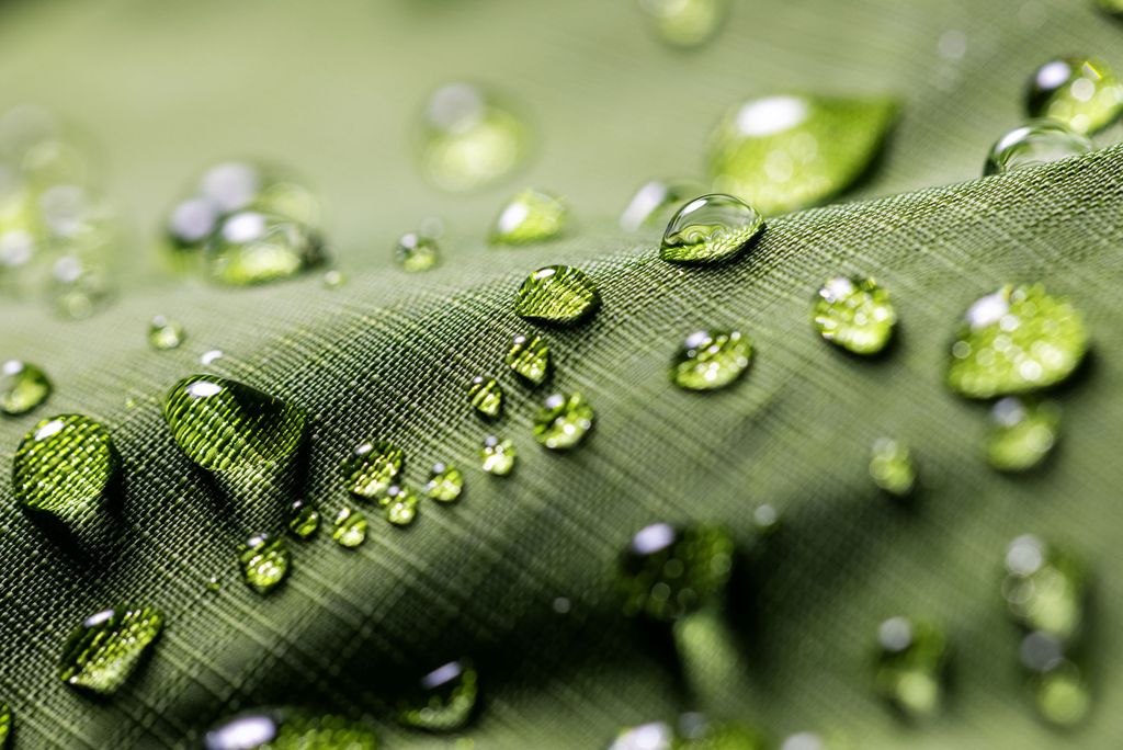 Photo: A green jacket with beads of water forming on the surface of the material