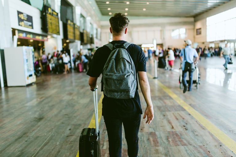 young man walking in the airport.