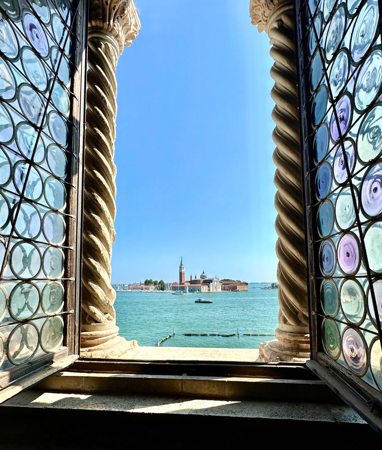 looking through a window to the harbor in venice italy