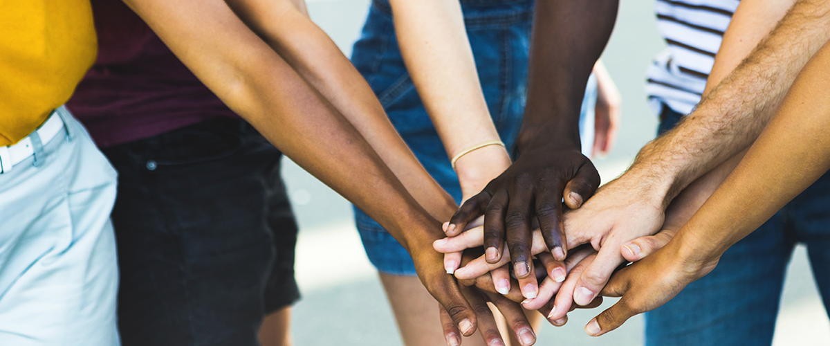 Diverse hands stacked on top of one another