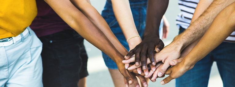 Diverse hands stacked on top of one another